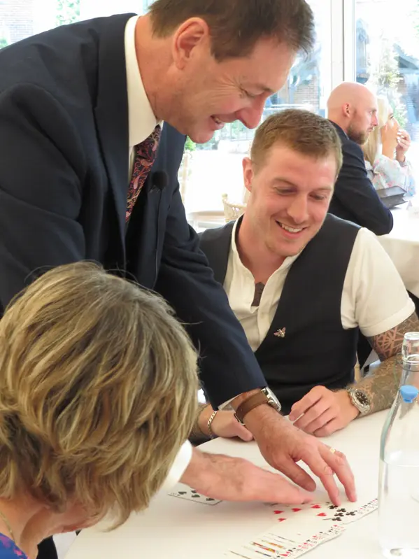 Corporate magician Dave Royal engaging guests at a formal venue